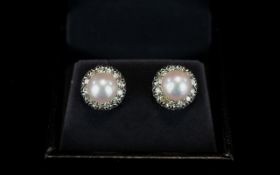 18ct White Gold Natural Pearl And Diamond Earrings A pair of white gold stud earrings set with