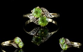 Ladies 9ct Gold Attractive Two Stone Twist Ring set with Peridot and Diamonds.