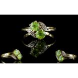 Ladies 9ct Gold Attractive Two Stone Twist Ring set with Peridot and Diamonds.