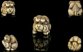 Japanese Superb Quality 19th Century Signed Carved Ivory Netsuke in the form of a dog figure in a