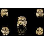 Japanese Superb Quality 19th Century Signed Carved Ivory Netsuke in the form of a dog figure in a