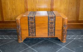 Chinese Camphor Wood Chest of shaped Deco form with a carved dragon and floral decoration,