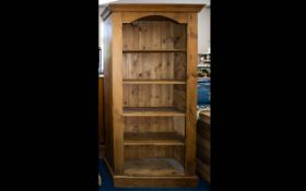 A Solid Pitched Pine Bookcase Large four shelf bookcase of traditional form,