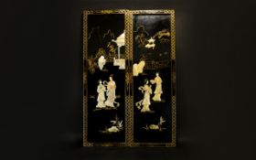 A Pair Of Oriental Panels Rectangular wood panels finished in black lacquer and gilt trim.