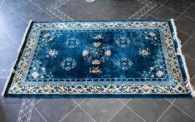 A Large Oriental Silk Rug Rectangular rug, purchased in Hong Kong, cerulean blue ground with cream,