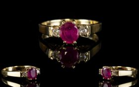 Ladies 9ct Gold Ruby and Diamond Dress Ring. The Central Ruby Flanked by Two Diamonds.