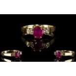 Ladies 9ct Gold Ruby and Diamond Dress Ring. The Central Ruby Flanked by Two Diamonds.