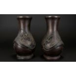 A Pair Of Early Twentieth Century Japanese Bronze Vases Each with embossed dragon motif.