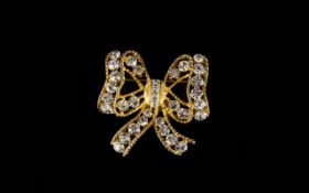 A Vintage Crystal Set Brooch By Eisenberg Gold tone brooch in the form of a bow,
