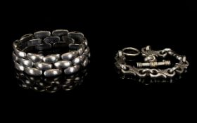 Two Contemporary Silver Bracelets Chunky statement bracelets, each stamped 925 silver.