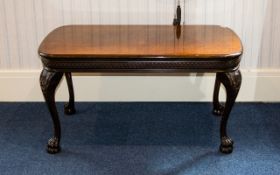 A Walnut Coffee Table Of rectangular form with carved apron, legs and claw and ball feet. Height