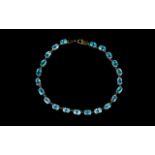 A 9ct Blue Topaz Tennis Bracelet Attractive bracelet set in 9ct yellow gold with 22 faceted oval