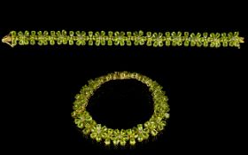 Peridot Floral Line Bracelet, 41cts of pear cut peridot set as stylised flowers in a single row,