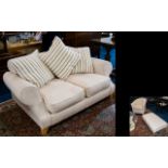 A Modern Two Seater Sofa Plush sofa upholstered in natural textured fabric. Complete with large