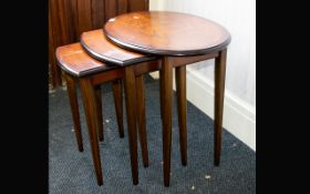 A Dark Wood Nest of Tables Three tables the tallest with oval top. Of plain form, good condition.