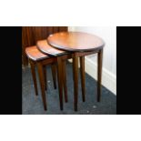 A Dark Wood Nest of Tables Three tables the tallest with oval top. Of plain form, good condition.