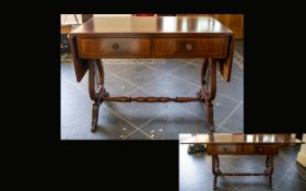 A Mahogany Sofa Table Of typical form with lyre shaped supports, turned cross stretcher, terminating