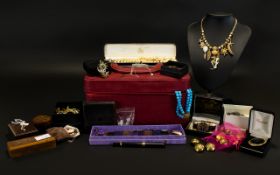 A Large And Varied Collection Of Costume Jewellery Housed in red faux leather vanity case,