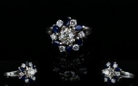 18ct White Gold Diamond and Sapphire Dress Ring, In a Flower head Design Setting. The Diamonds and