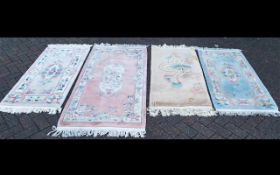 Four Rectangular Oriental Style Wool Rugs. Various pastel colours and designs with tasseled edges.