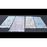 Four Rectangular Oriental Style Wool Rugs. Various pastel colours and designs with tasseled edges.