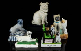 A Collection Of Ceramic Pug Dog Figurines Five in total, mostly late 19th/early 20th century to