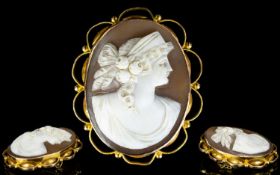 9ct Gold Mounted Shell Cameo Brooch with attached 9ct gold safety chain. Marked 9ct. Depicts