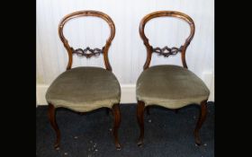 A Pair of Walnut Parlour/Salon Chairs balloon back with padded seats.