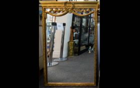 A Large Reproduction French Empire Style Mirror Large bevelled glass mirror in ornate yellow gilt