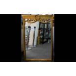 A Large Reproduction French Empire Style Mirror Large bevelled glass mirror in ornate yellow gilt