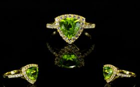 Peridot Trillion and White Topaz Ring, a 2.5ct trillion cut peridot of good colour, with .