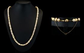 A Nice Quality Single Strand Pearl Necklace with a 14ct Gold Clasp and Safety Chain.