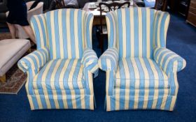 A Pair of Wing Back Arm Chairs Two arm chairs with high wing backs, upholstered in blue and yellow