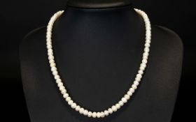 A Single Strand Pearl Necklace with a diamond set clasp. Length 9 inches.