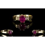 Ladies 9ct Gold Ruby and Diamond Dress Ring. The Central Ruby Flanked by Two Diamonds. All of Good