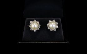 18ct White Gold - Pair of Nice Quality Diamond and Pearl Set Earrings. The Central Cultured Pearl to