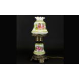 A Decorative Brass and Ceramic Oil Lamp, Raised on ornate brass footed base with central, floral