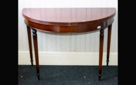 A Mahogany Gate Fold Console Table. Circular top with Neoclassical style legs and hinged top. Dia 41