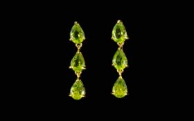 Peridot Triple Drop Earrings, each earring being three pear cut peridots in a single,
