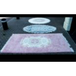 Three Wool Rugs. Two circular wool rugs, one white and pink, one pastel blue and a further pink