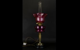 Cranberry Glass and Brass Oil Lamp Converted oil lamp on circular base with brass stand and fluted /