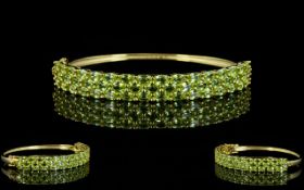 Peridot Three Row Bangle, three rows of closely set, oval cut, bright green peridots,