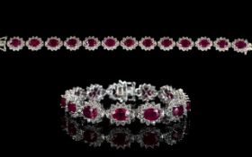 Ruby and Natural White Zircon Line Bracelet, 34cts of oval cut rubies framed with round cut