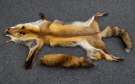 A Red Fox Pelt Full pelt in good condition, tail intact. Along with a single red fox brush - Fur