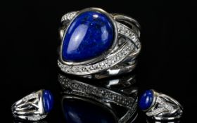 Lapis Lazuli and White Topaz Ring, a 10ct lapis lazuli cabochon set on a platinum vermeil and silver