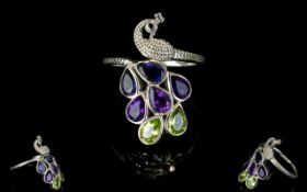 Amethyst, Peridot and Iolite Peacock Ring, a detailed silver peacock with two iolites,