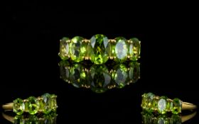 Peridot Five Stone Ring, the five oval cut, graduated peridots centred by one of 2cts,