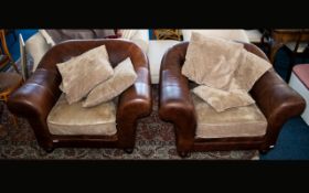 A Pair Of Large Contemporary Leather Armchairs Two in total,