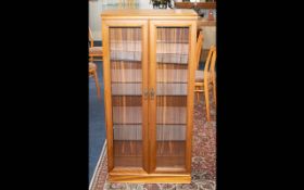 Glazed Display Cabinet Two door cabinet with glazed doors and brass pulls.