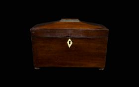 A 19th Century Mahogany Tea Caddy Of Sarcophagus Form With ivory escutcheon raised on bun feet,